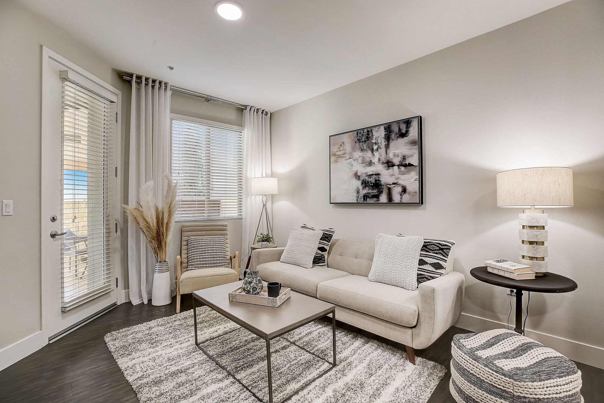 Modern living room in Aria Apartments with sleek furniture and large windows